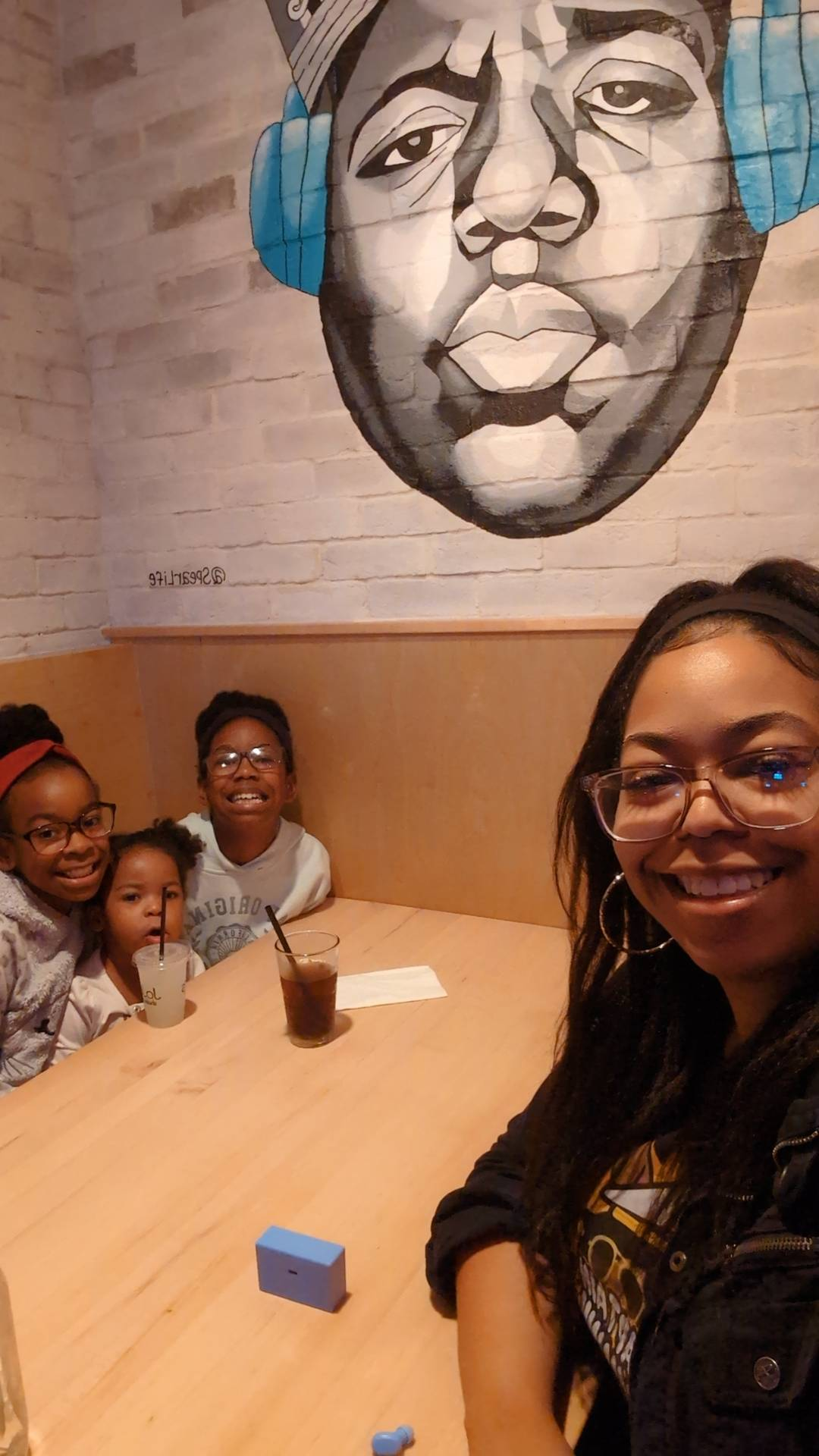 Sam smiling with her three daughters